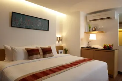a bedroom with a large white bed in a room at Citypoint Hotel in Bangkok