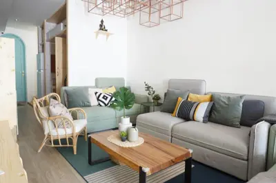a living room with a couch and a table at Pinto Hostel in Bangkok