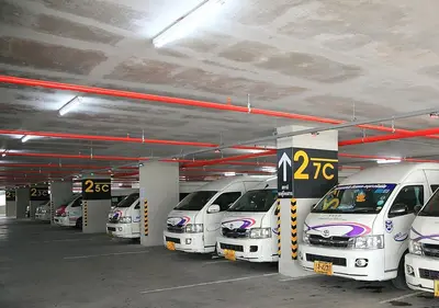 a row of cars parked in a parking garage at New Room in Nonthaburi
