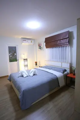 a bedroom with a large bed with two pillows on it at TD Bangkok in Bangkok