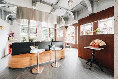 a restaurant with a bench and tables in a room at Talakkia Boutique Hotel in Bangkok