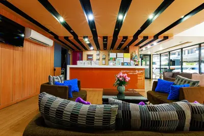 a lobby with couches and a bar at PDA Lord Hotel in Bangkok