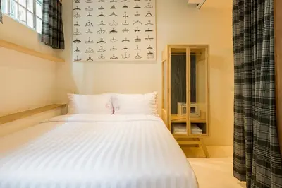 a bedroom with a white bed in a room at The Pattern Boutique Hotel in Bangkok
