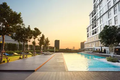 a swimming pool in the middle of a building at The Quarter Ladprao by UHG in Bangkok