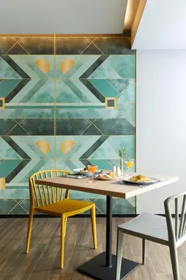 a dining room with a table and chairs and a mural at The Quarter Ladprao by UHG in Bangkok