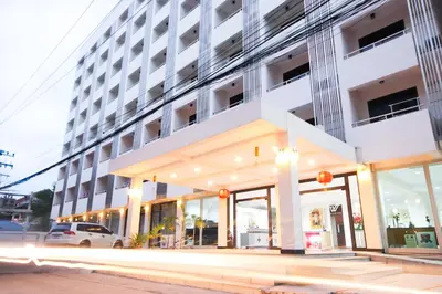 a large white building with a car parked in front of it at White House Bizotel in Bangkok