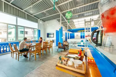 two people sitting at a table in a restaurant at Ama Hostel Bangkok in Bangkok