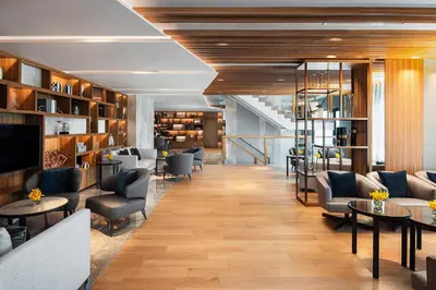 a hotel lobby with couches and chairs and tables at Hotel Nikko Bangkok in Bangkok