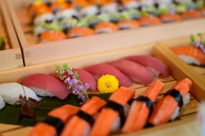 a tray of sushi with carrots and other foods at Hotel Nikko Bangkok in Bangkok