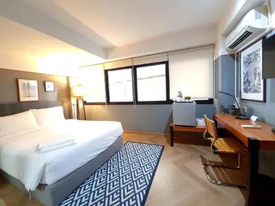 a hotel room with a bed and a desk and a desk at Somewhere to Escape - Hometel in Bangkok