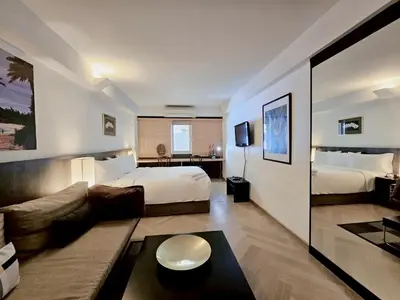 a hotel room with a bed and a couch at Somewhere to Escape - Hometel in Bangkok
