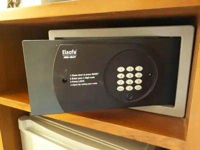 a microwave oven sitting on top of a refrigerator at New Siam III Guest House in Bangkok