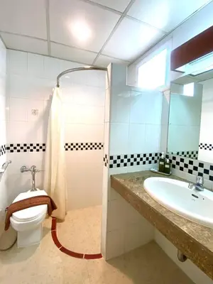 a bathroom with a toilet and a sink at New Siam III Guest House in Bangkok