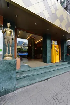 a statue of a man standing outside of a building at Arawana Regency Park Sukhumvit in Bangkok