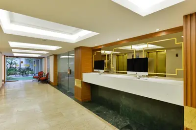a bathroom with two sinks and a large mirror at Arawana Regency Park Sukhumvit in Bangkok