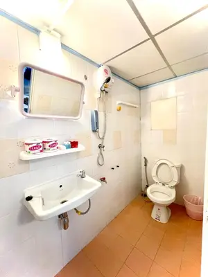 a bathroom with a sink and a toilet at 4J Lodge in Bangkok