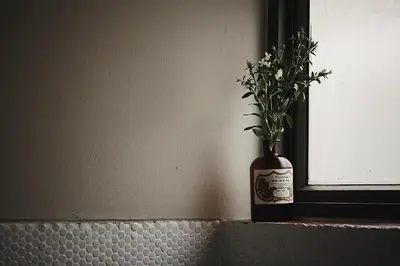 a vase with flowers in it sitting on a ledge at Ob-Oon Boutique Bed & Breakfast in Bangkok