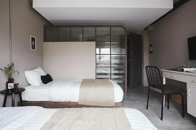 a hotel room with two beds and a desk and a desk at Ob-Oon Boutique Bed & Breakfast in Bangkok