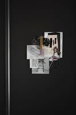 a collage of pictures on a black wall at Ob-Oon Boutique Bed & Breakfast in Bangkok