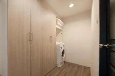 a laundry room with a washer and a washing machine at Aspira Residence Ruamrudee in Bangkok