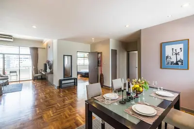 a dining room and living room with a dining table at Asoke Residence Sukhumvit by UHG in Bangkok