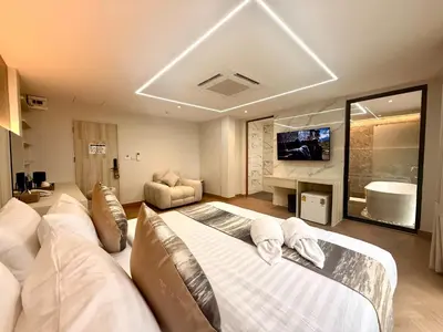a bedroom with a large bed and a tv at Bed by Tha-Pra SHA Plus in Bangkok