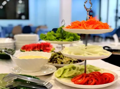 a table with three plates of vegetables on plates at Bed by Tha-Pra SHA Plus in Bangkok