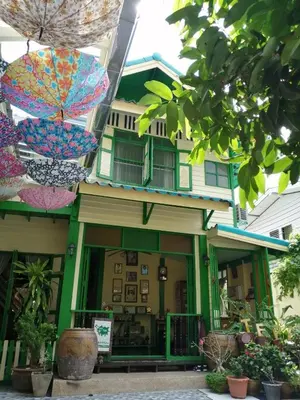 a building with umbrellas hanging in front of it at Baan Tepa Boutique House in Bangkok