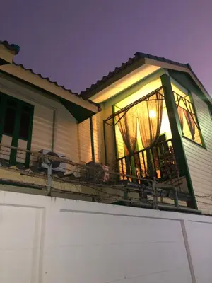 a screened in porch on a house at night at Baan Tepa Boutique House in Bangkok