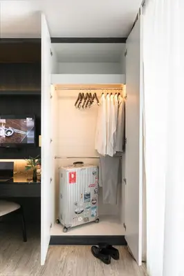 a room with a closet with a radiator at Apartelle Jatujak Hotel in Bangkok