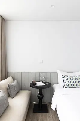 a room with a bed and a table and a couch at Apartelle Jatujak Hotel in Bangkok