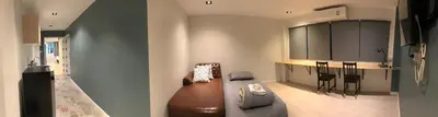 a living room with a couch and a kitchen at Alley living rama8 in Bangkok