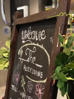 a chalkboard sign that says welcome to the alley living at Alley living rama8 in Bangkok
