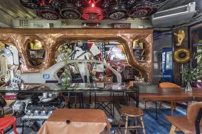a room with a table and some plates on the wall at MeStyle Garage Hotel in Bangkok