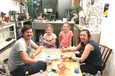 a group of people sitting at a table at Bangkok Sanookdee Hostel in Bangkok