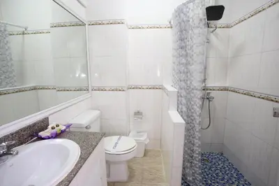 a bathroom with a sink and a toilet and a shower at PJ Watergate Hotel in Bangkok