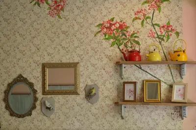 a wall with two mirrors and a shelf with pictures at Phranakorn-Nornlen in Bangkok