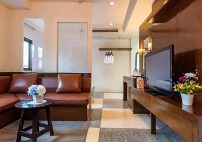 a living room with a couch and a flat screen tv at D&D Inn Khaosan in Bangkok