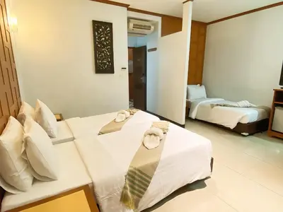 a hotel room with two beds with a tie on them at New Siam II in Bangkok