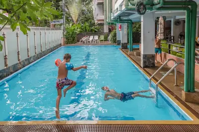 two boys playing in a swimming pool at New Siam II in Bangkok