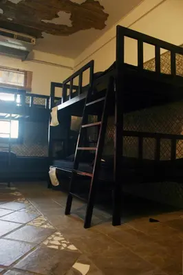 a room with two bunk beds and a ladder at Born Free Hostel in Bangkok