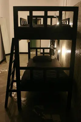 a bunk bed in a room with a light at Born Free Hostel in Bangkok