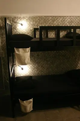 two bunk beds in a room with lights at Born Free Hostel in Bangkok