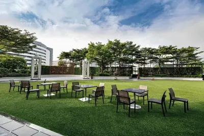 a group of tables and chairs on a lawn at Grande Centre Point Hotel Terminal21 in Bangkok