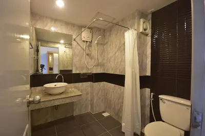 a bathroom with a sink and a toilet and a shower at LOFT Salaya in Salaya