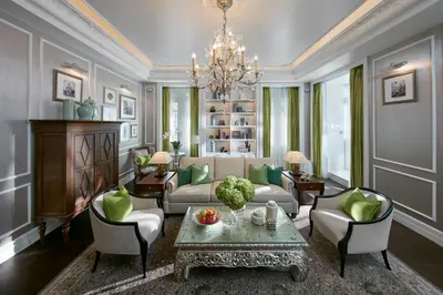 a living room with a couch and a table and chairs at Mandarin Oriental, Bangkok in Bangkok