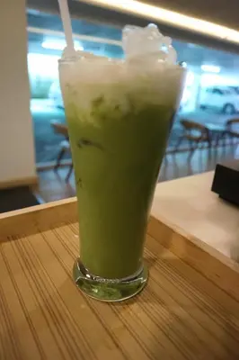 a drink in a glass sitting on a table at Ebina House - SHA Extra Plus in Bangkok
