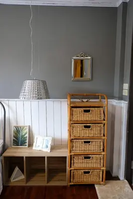 a room with a bed with a table and baskets at TANA CASA 12 Large Sathorn 6BR Townhome with Parking in Bangkok