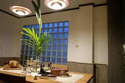 a table with a plant in front of a window at TANA CASA 12 Large Sathorn 6BR Townhome with Parking in Bangkok