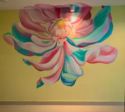 a mural of a flower on a wall at Salin Home Hotel Ramkhamhaeng in Bangkok